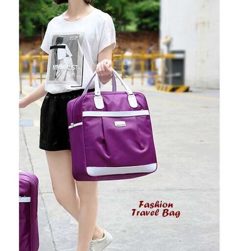 a woman carrying a purple bag on her shoulder.