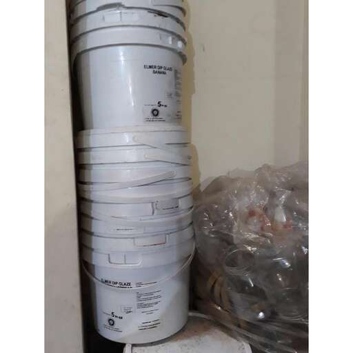 a stack of cups sitting on top of a white shelf.