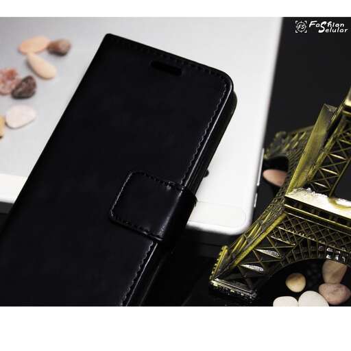 a cell phone sitting next to a black case.