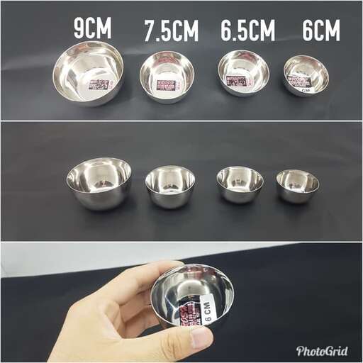a hand holding a bowl of pills.