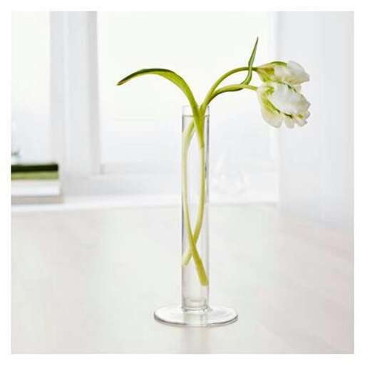 a glass vase with a flower in it.