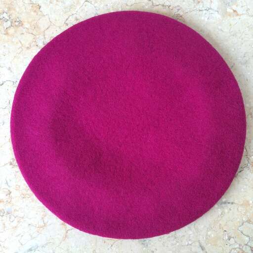 a round purple ball of wool in a pink circle