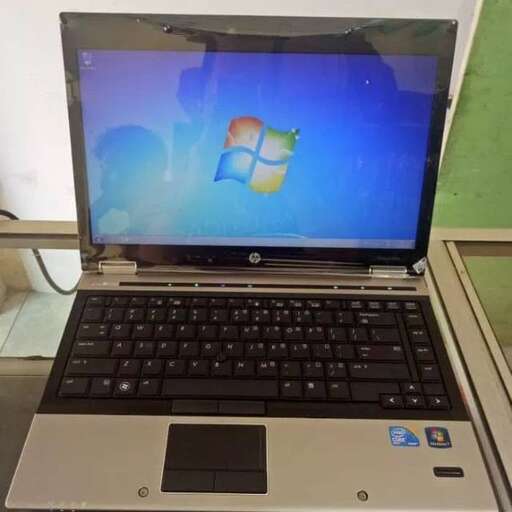 a laptop computer with a blue screen and a green background
