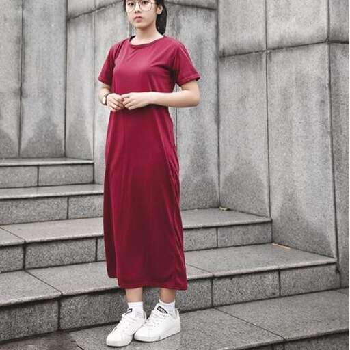 a woman in a red dress standing on steps.