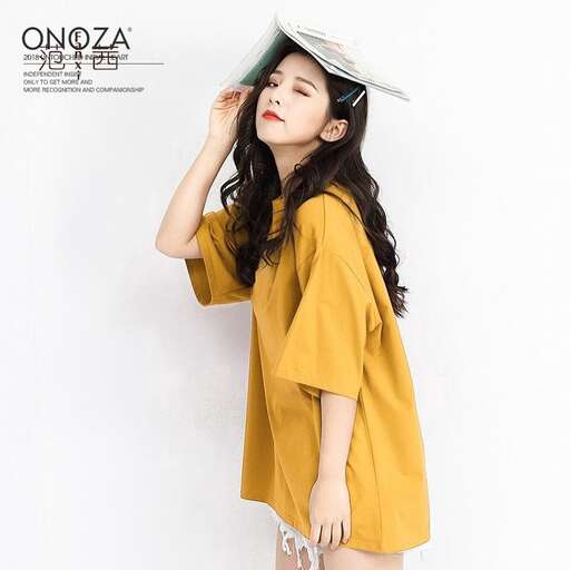 a woman in a yellow shirt and a hat