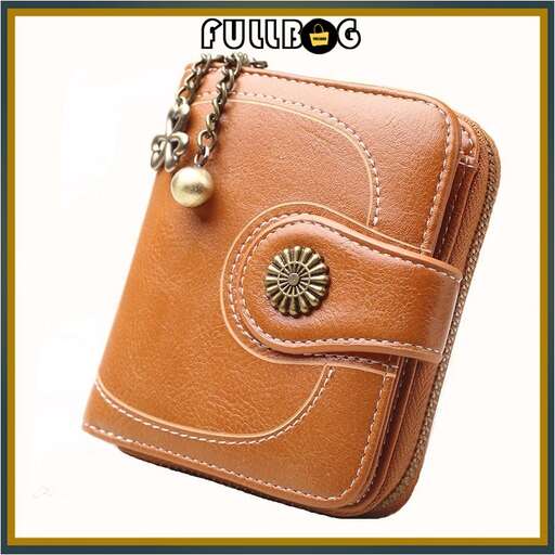 this is a small leather wallet with a gold bead and a pearl necklace.