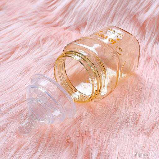 a glass bottle with a lid on a pink fur