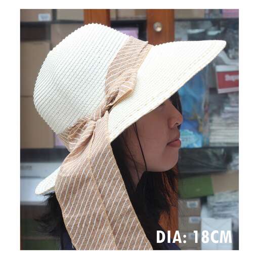 a woman in a hat in a shop window