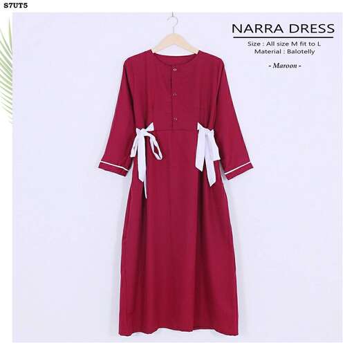 a long sleeved dress with a bow on the back