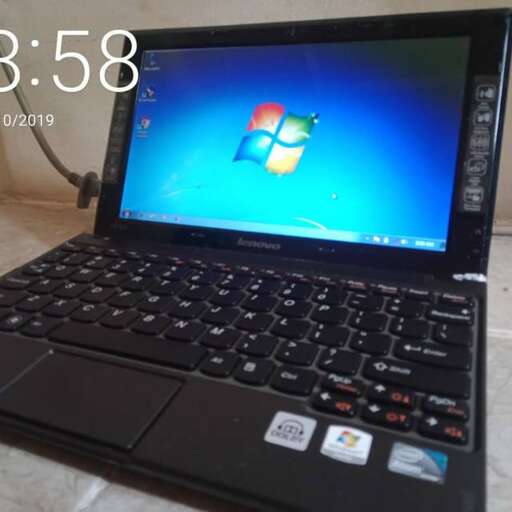 a laptop computer with a blue screen and a black keyboard.