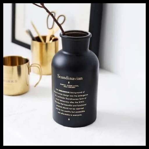 a black bottle with writing on it.
