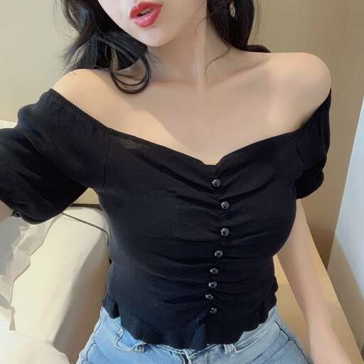 a woman in a black top and blue jeans.