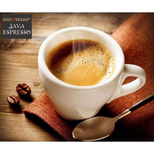 a cup of coffee on a wooden table.