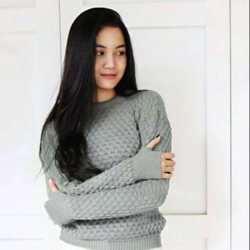 person in a sweater with arms crossed