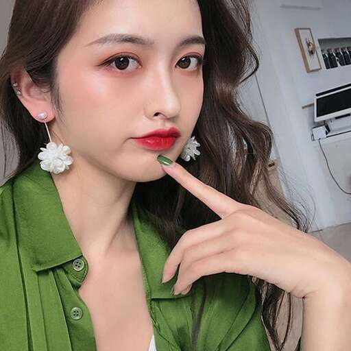 person with a flower in her mouth