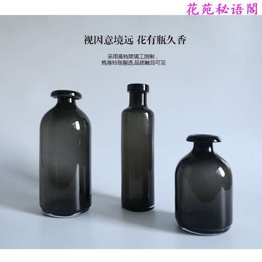 three black bottles with a white background.