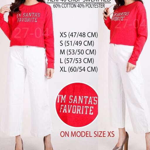 person is wearing a red sweater with white pants and white pants