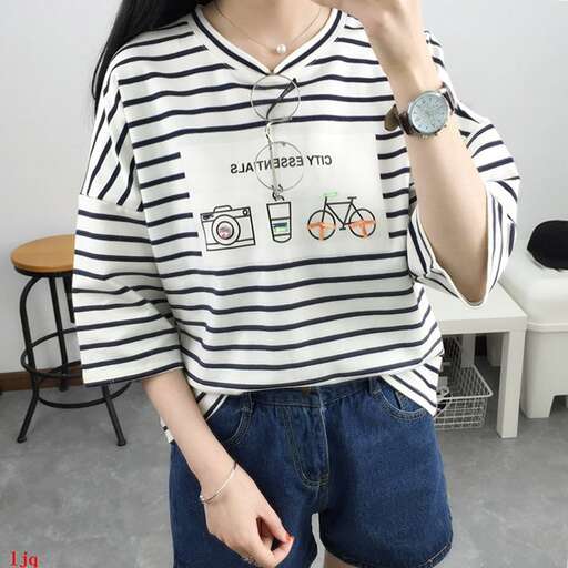 a girl in a striped t - shirt with a t - shirt underneath.