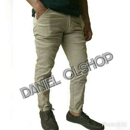 a man in a black shirt and khaki pants