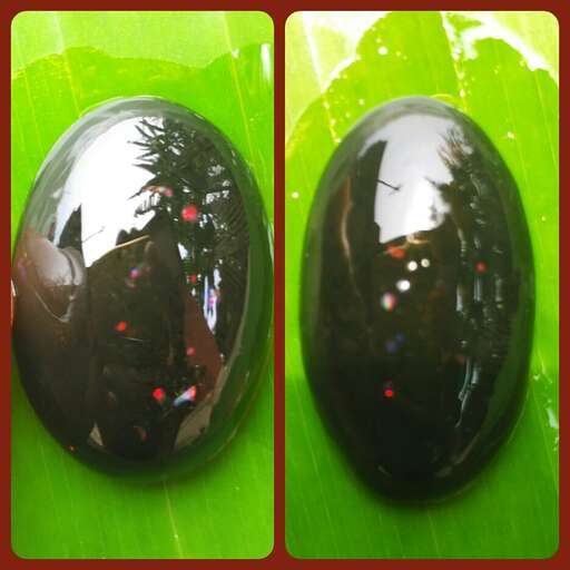 a black marble with a tree in the background