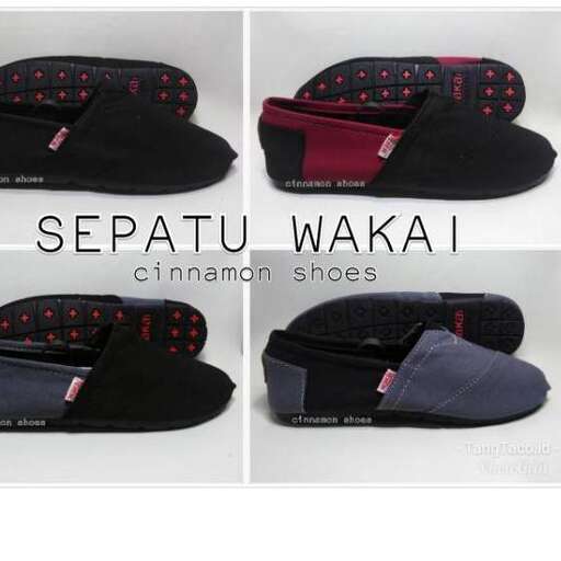 a pair of black slippers with red and black accents.