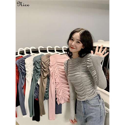 a girl standing in a closet with a rack of clothes.
