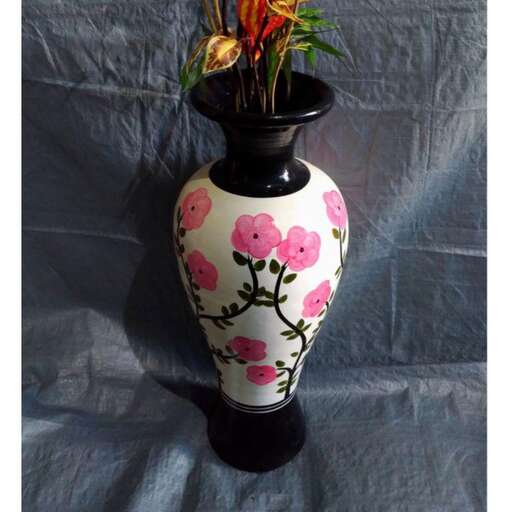 a vase with a pink flower on it