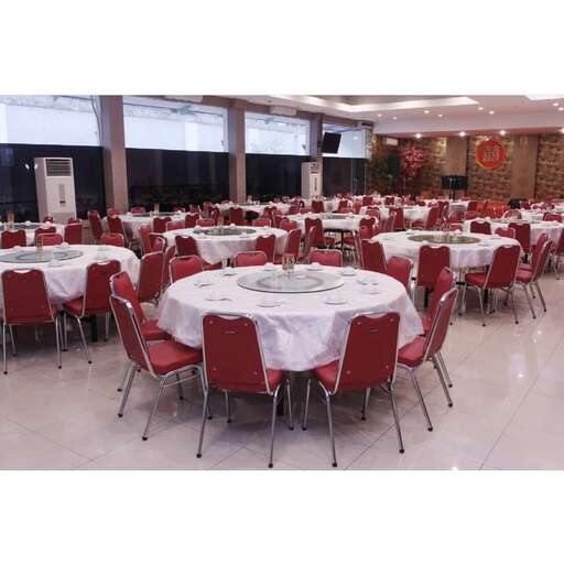 a large room with tables and chairs with a white tablecloth.