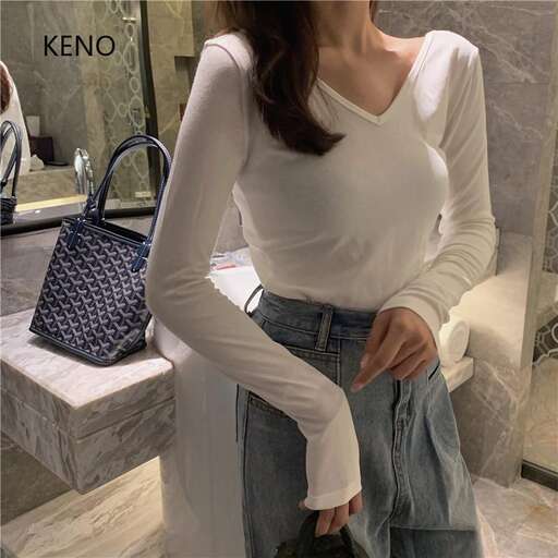 a woman is standing in front of a mirror.