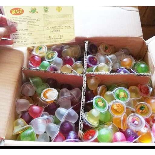 a box of plastic cups filled with candy.
