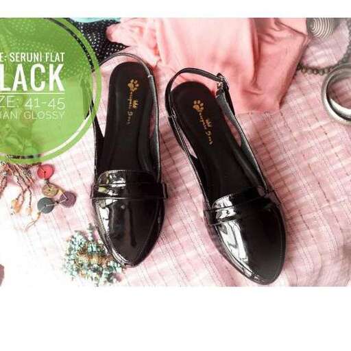 a pair of black shoes with gold accents.