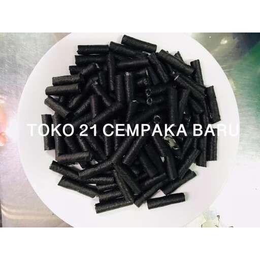 a white plate topped with black pieces of food.