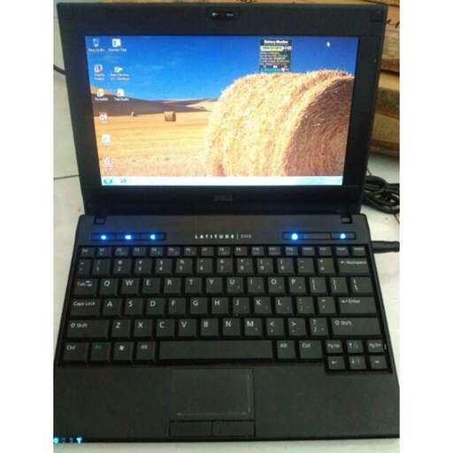 a laptop with a blue led screen and a picture of a straw.