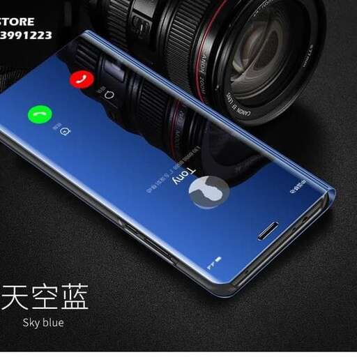 a blue cell phone is next to a camera.