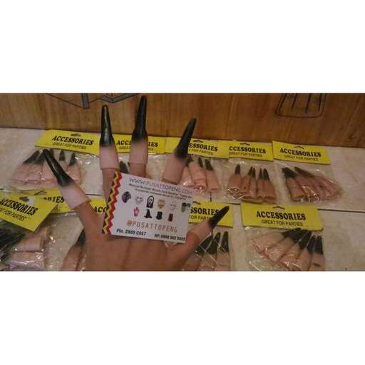 a person holding a package of nails with scissors.