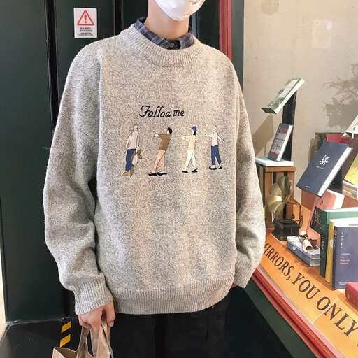 a man wearing a grey sweater with a white face and black pants.