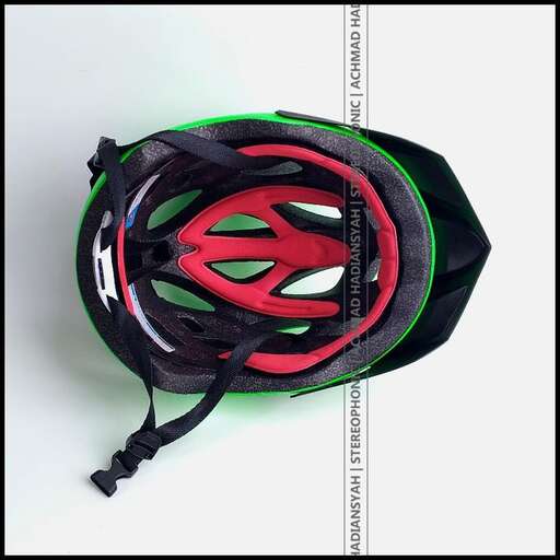 the helmet is in a black and green color.