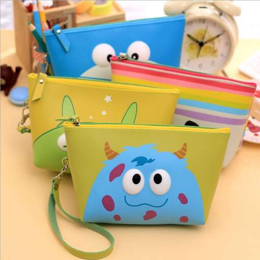 a colorful purse with a blue monster on it