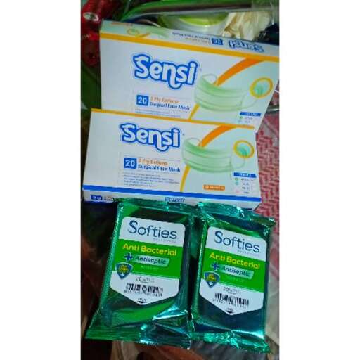 a package of green and white tissue paper sitting on top of a table.