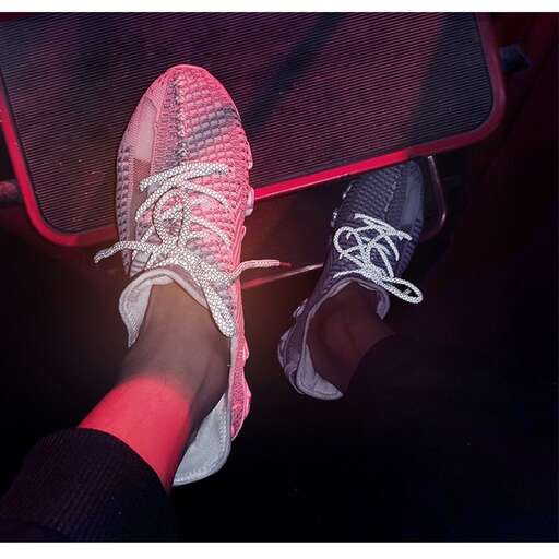 a pair of feet with white shoes and socks.