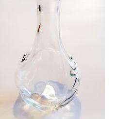 a glass vase with a small object inside of it.