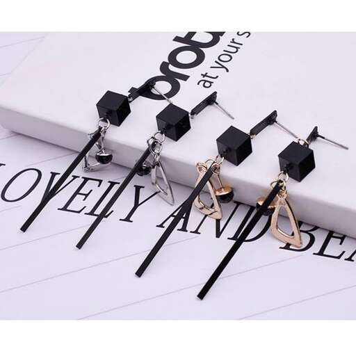 a piece of paper with two earrings and a ring.