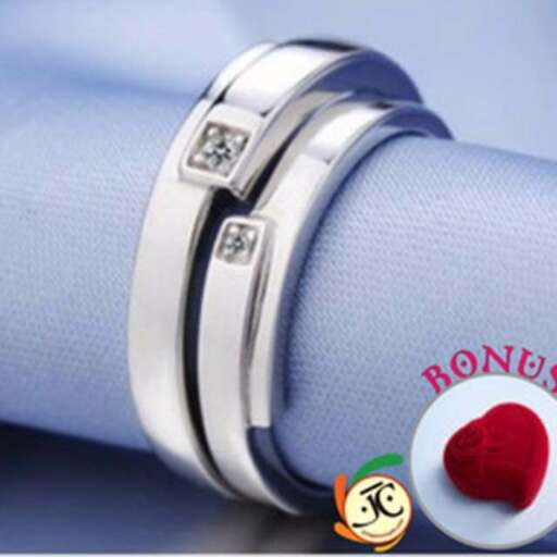 the bracelet is made of silver and has a red heart.