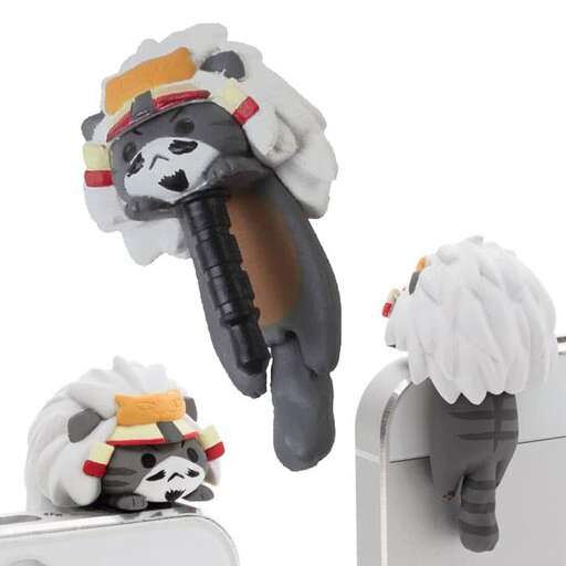 a stuffed animal with a remote control on top of a refrigerator.
