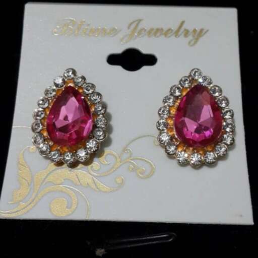 pink sapphires and diamond earrings in 18k gold with a pink sapphire.