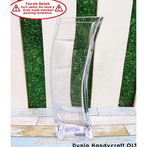 a glass vase is sitting on a table.