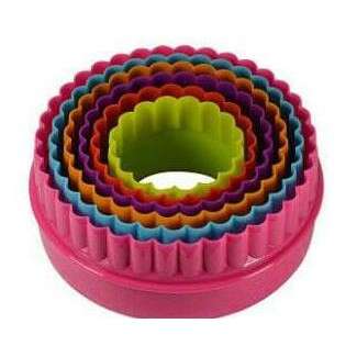 a colorful plastic container with a hole in the middle.