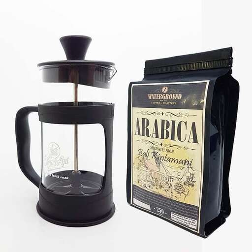 a lantern that is on a table next to a bottle.