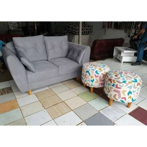 a living room with a couch and ottoman.