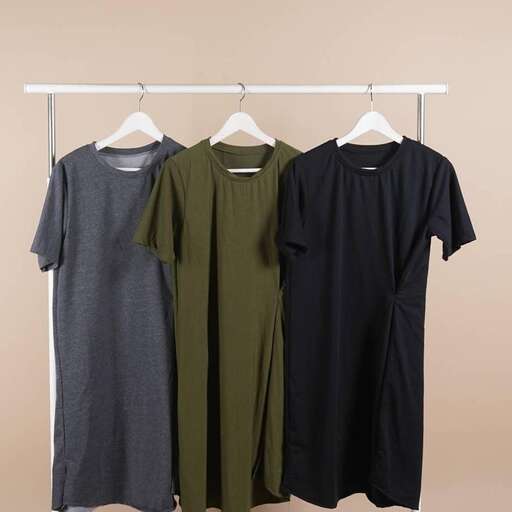 a group of dresses hanging on a rack.